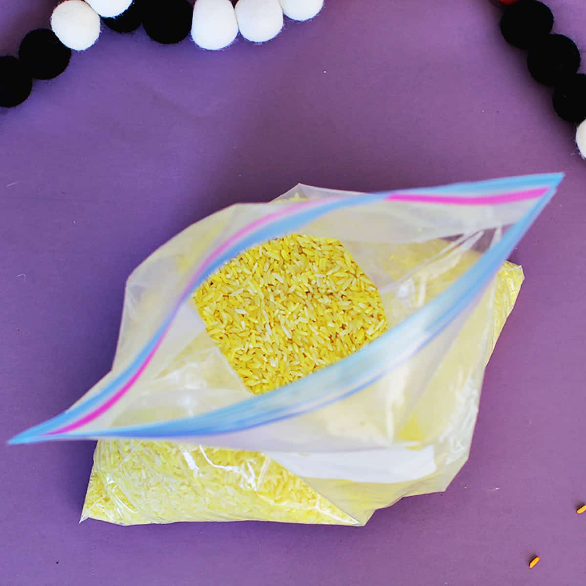 galloon ziploc baggie filled with rice dyed yellow.