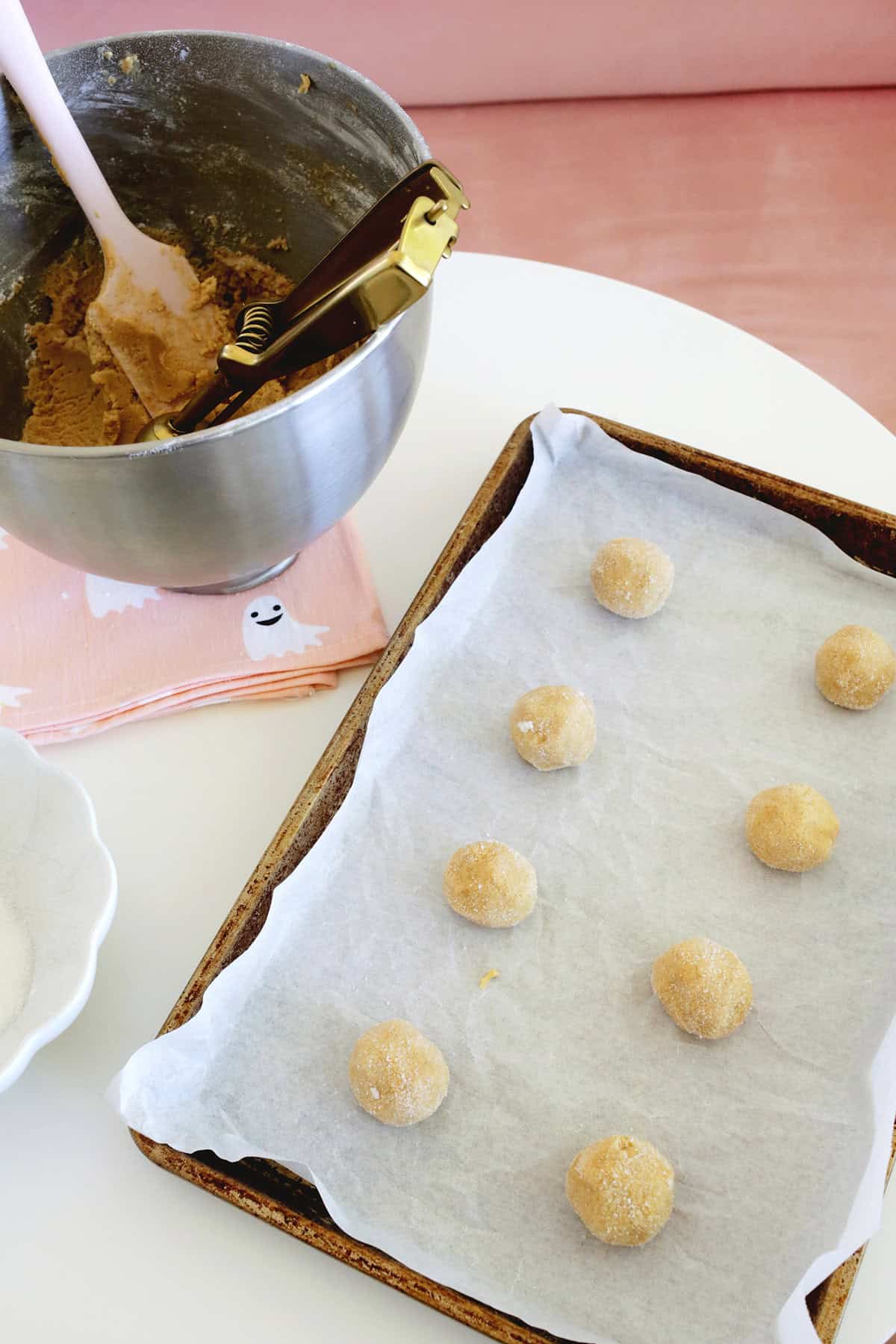dough balls rolled and placed on a baking sheet.