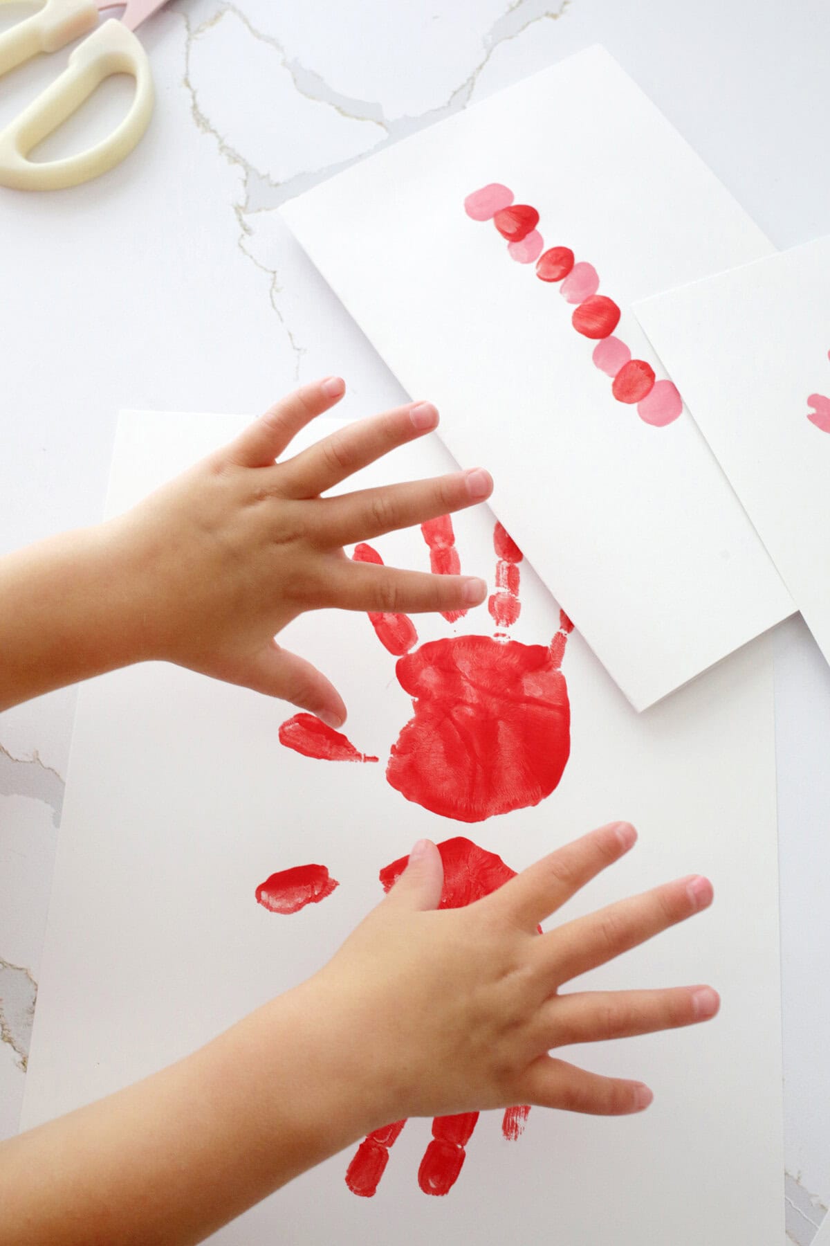 kids hands in front of painted handprints