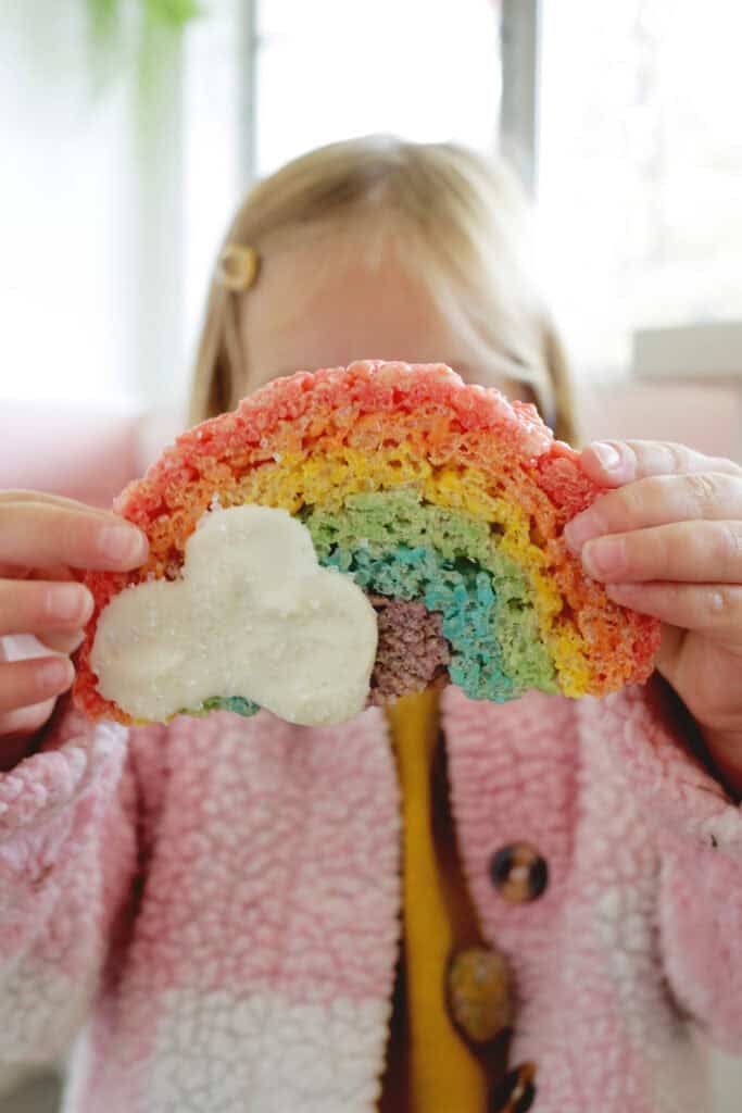 child holding rainbow rice krispies treat