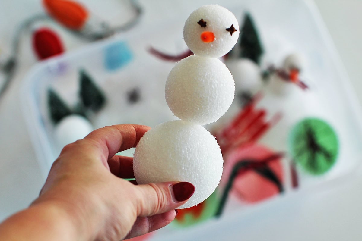 using toothpicks to hold together styrofoam balls and build a snowman craft.