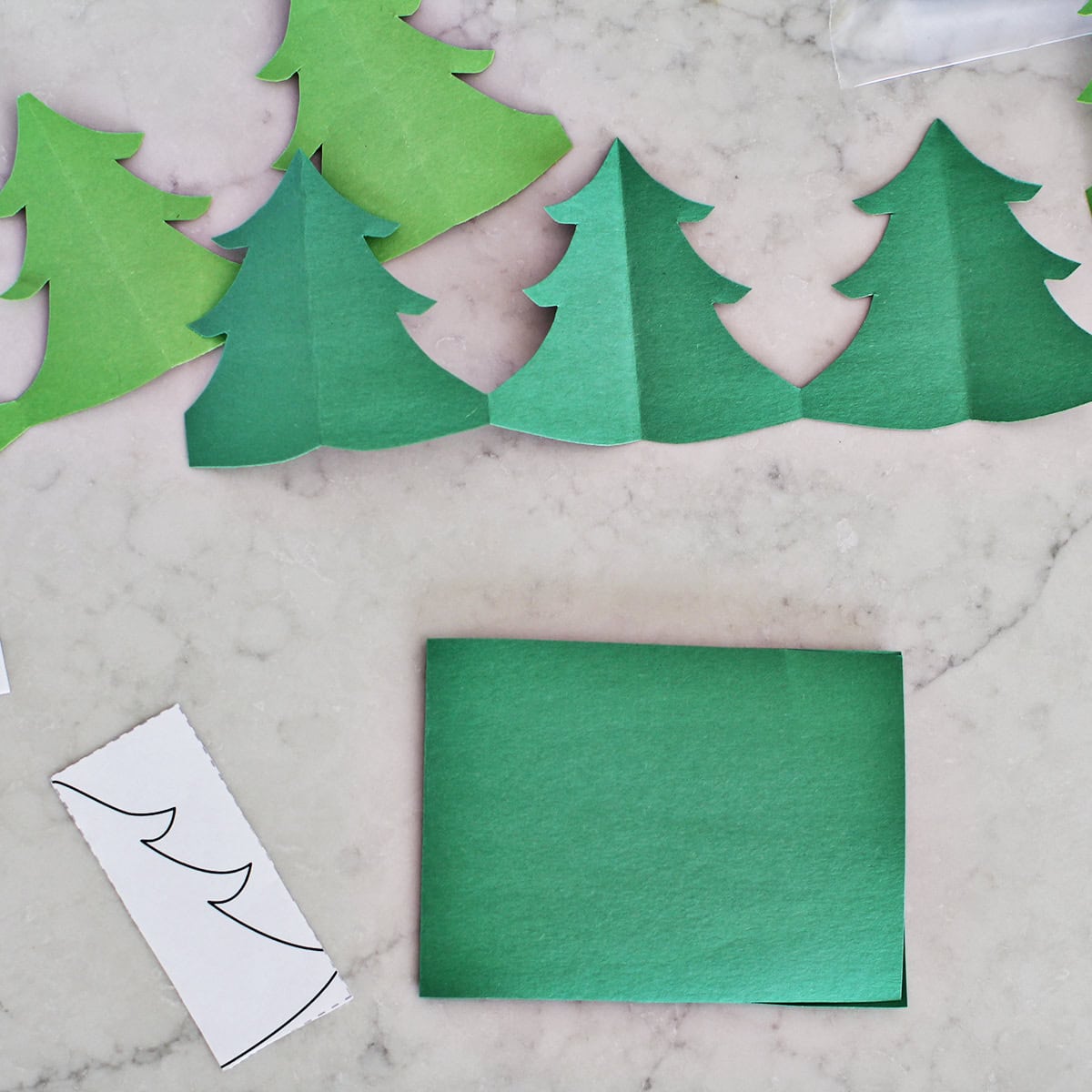 construction paper folded in half to make paper chain.