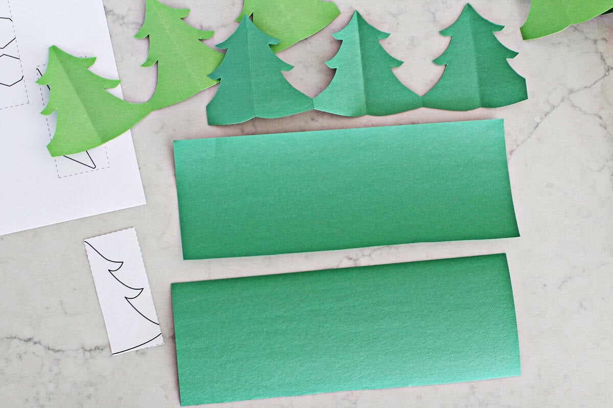green construction paper cut in half length wise on counter.