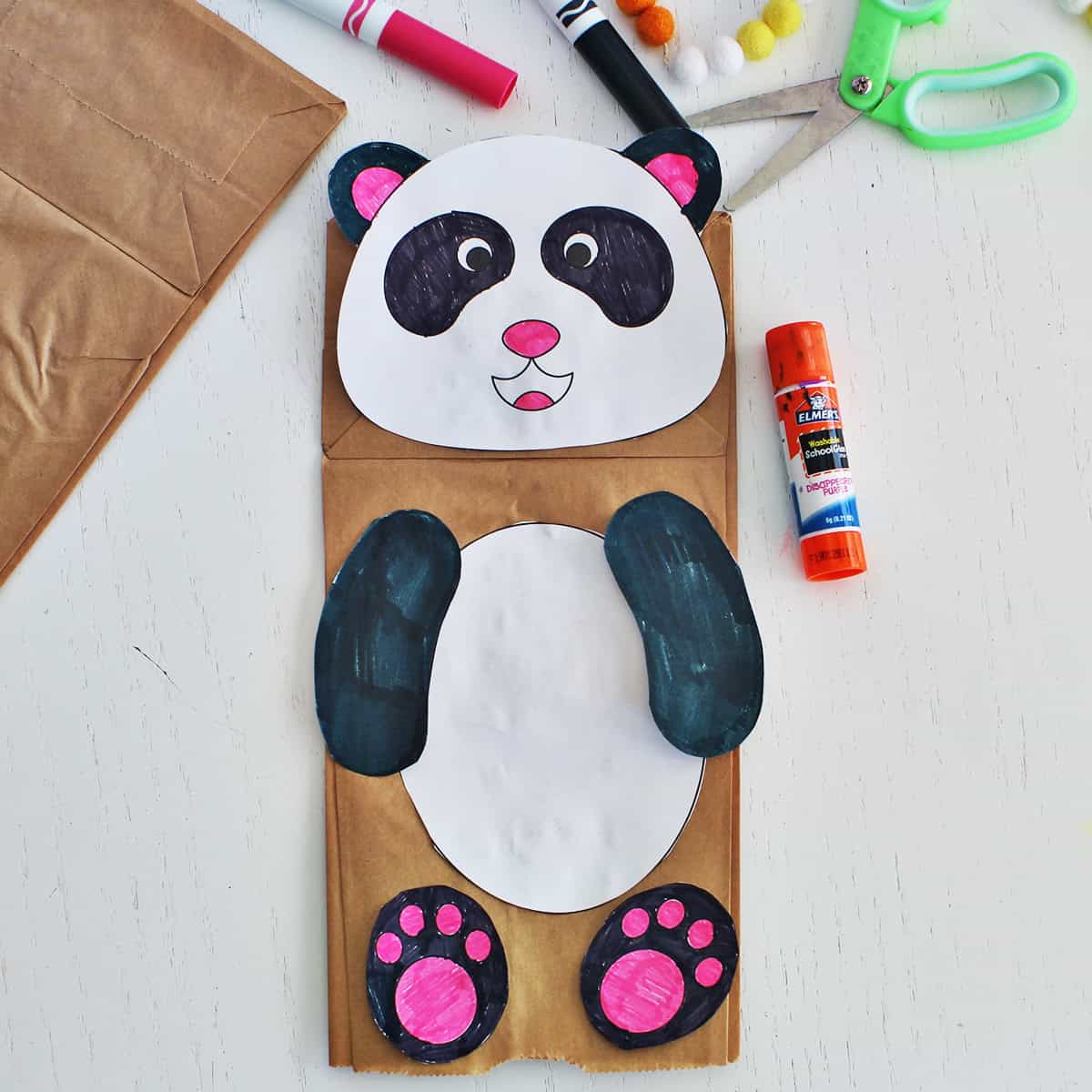 Paper bag puppet made to look like a panda.