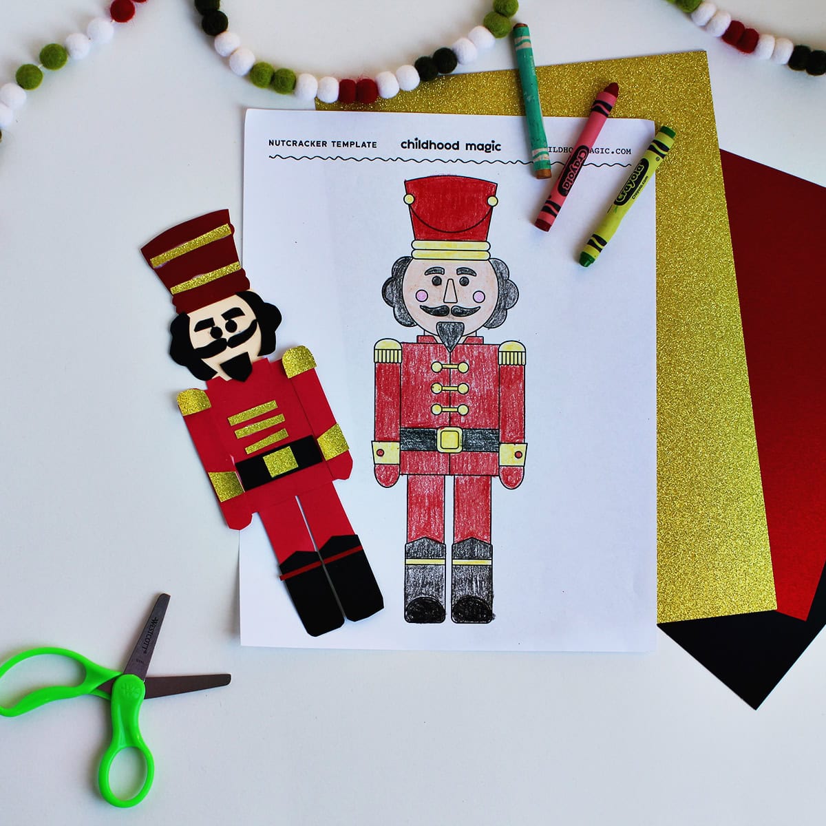 Crafted nutcracker from cardstock next to a colored in page of a nutcracker.