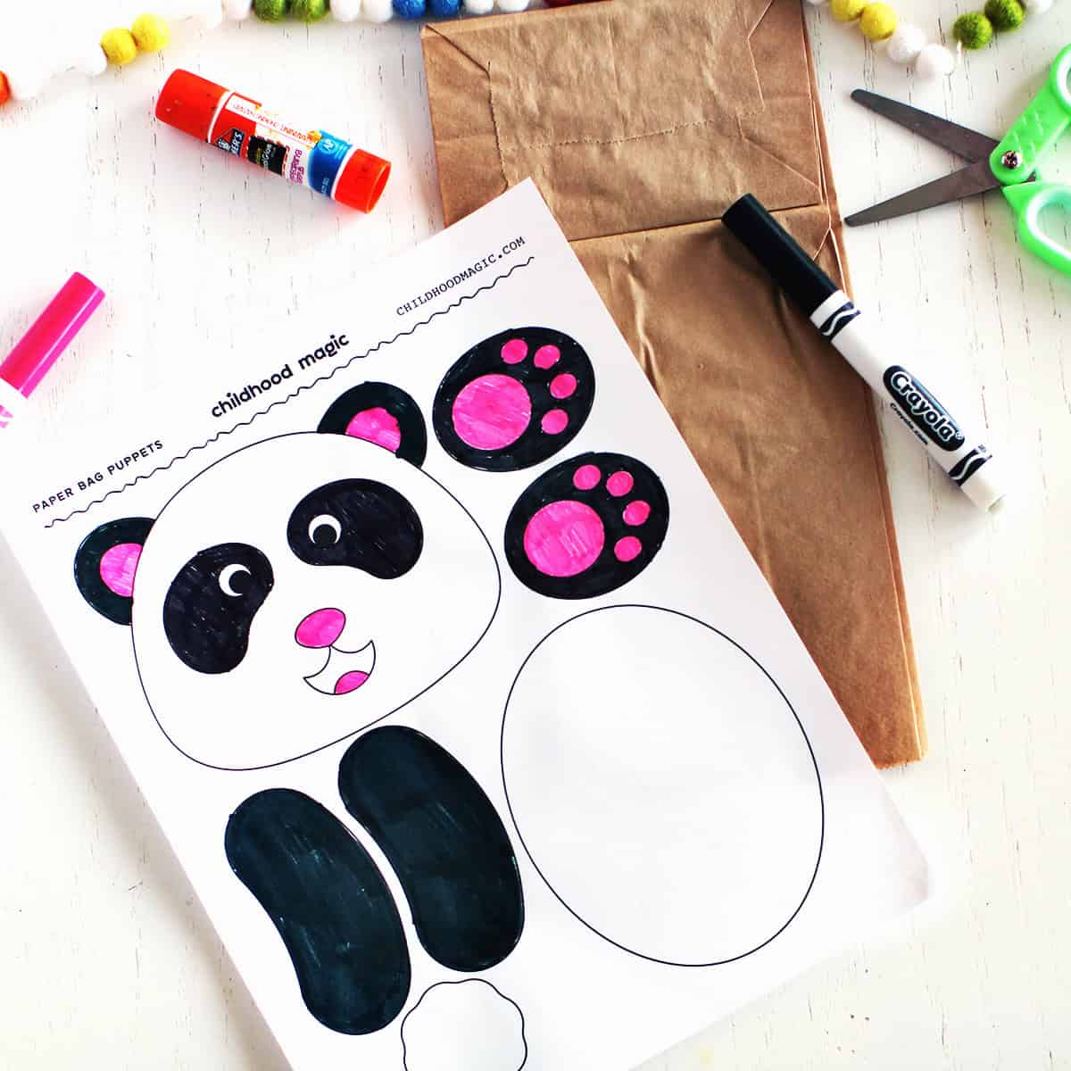 Colored in page with panda head, body, paws and tail to make a paper bag puppet.