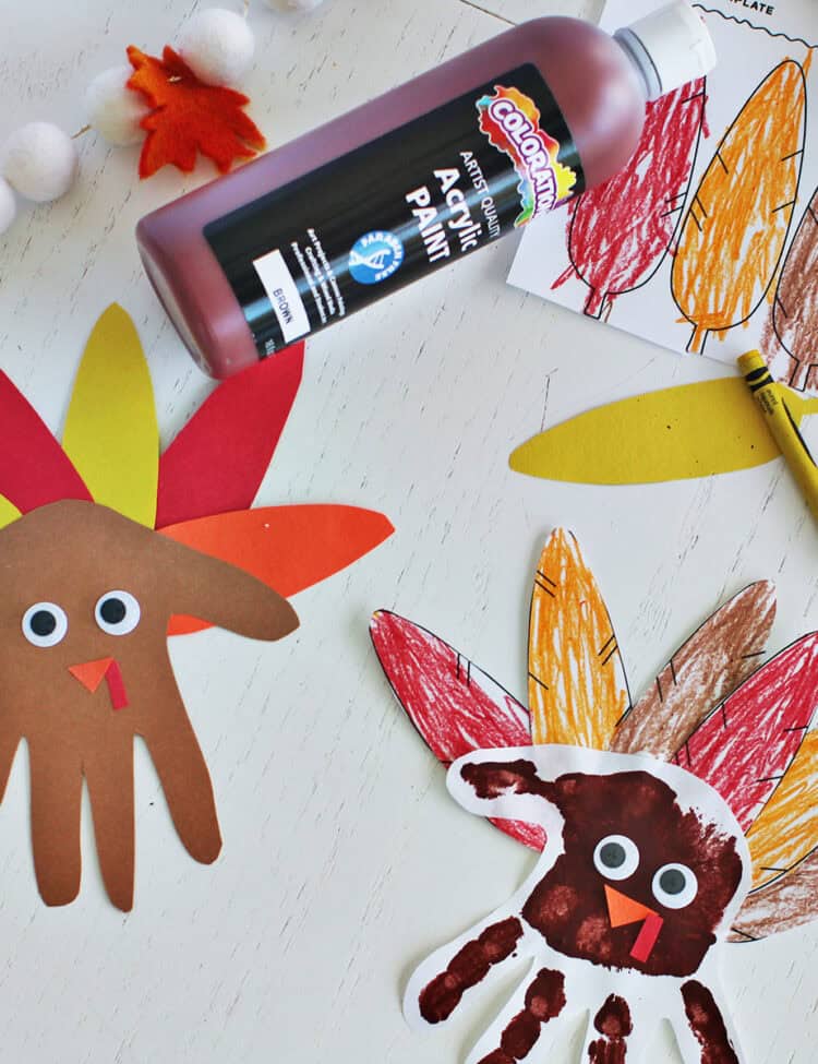 Thanksgiving turkey handprint crafts with paint, construction paper and printed feathers.