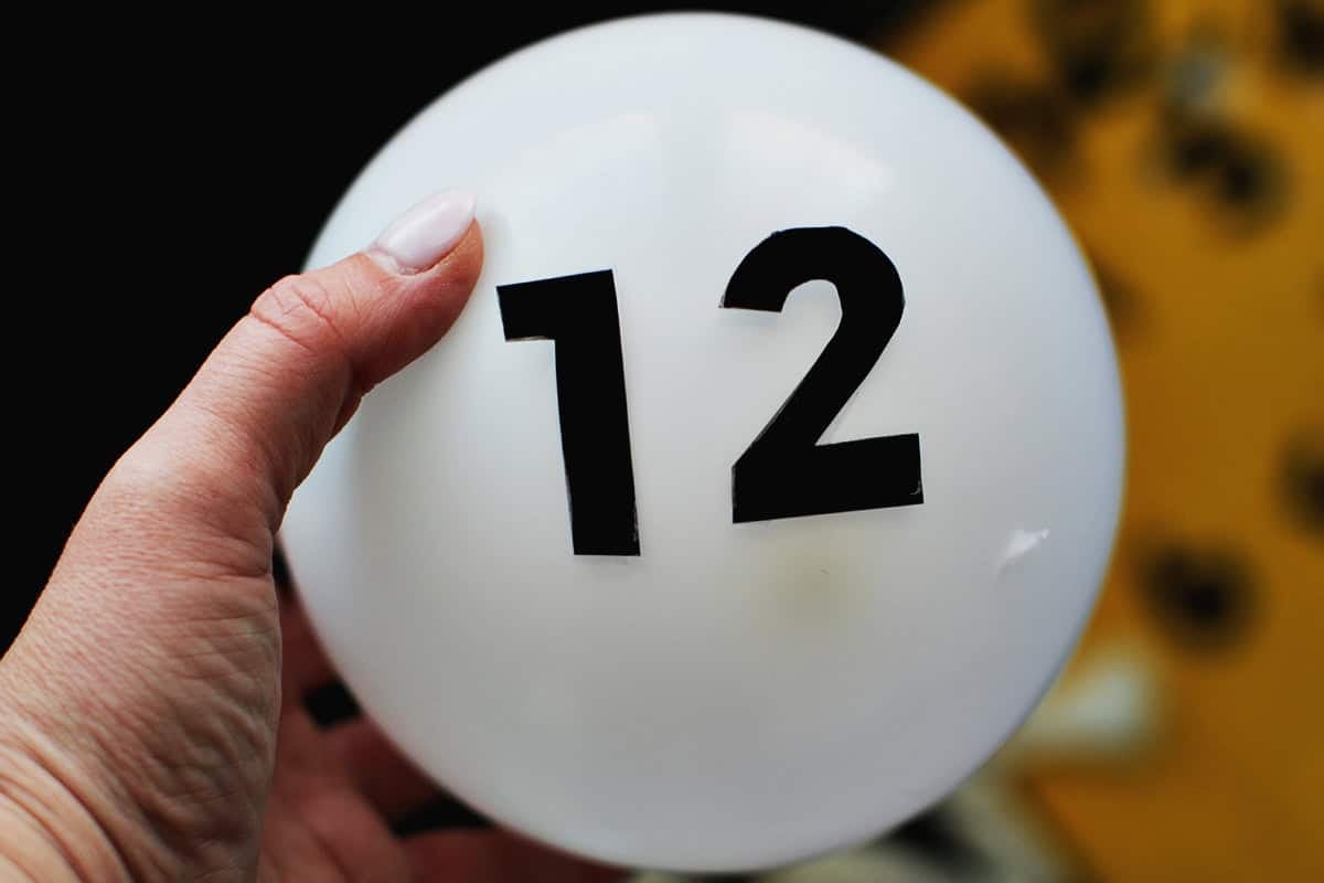 white balloon with black cardstock numbers added to it.