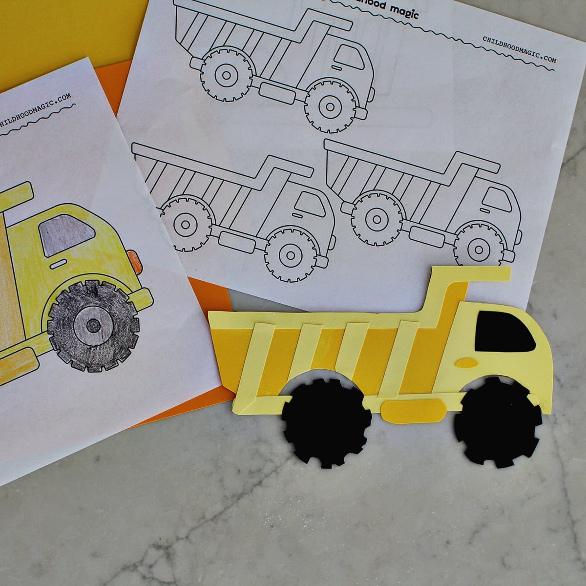 yellow dump truck cut out from cardstock next to a dump truck coloring page.