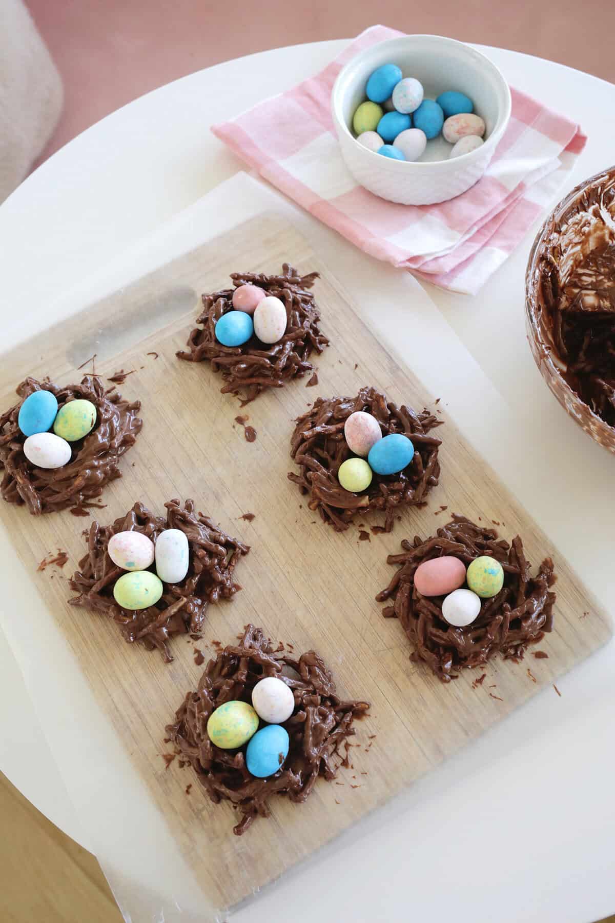 bird's nest cookies sitting on a cutting board and wax paper.