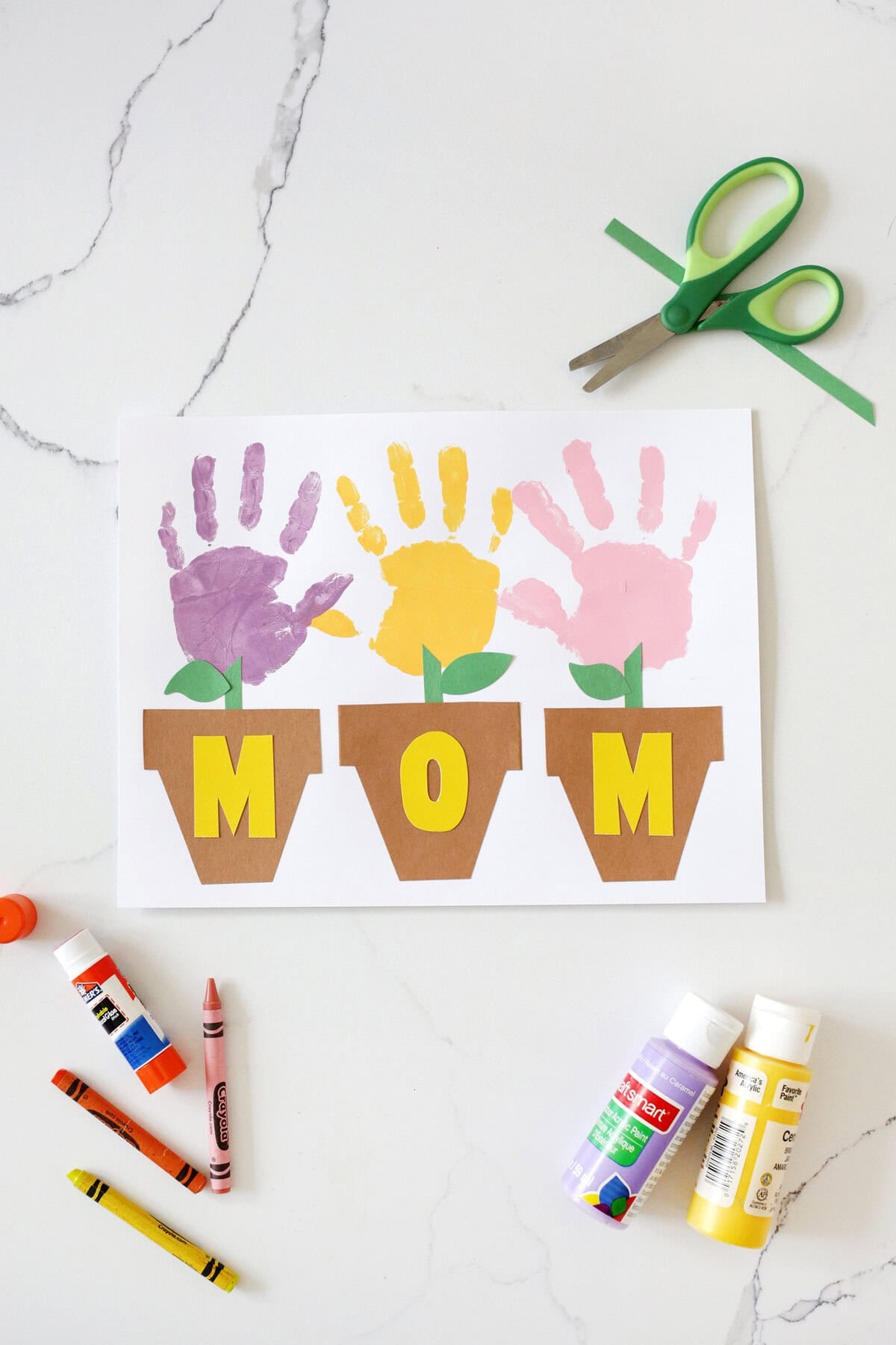 Handprint flowerpot Mother's Day craft with MOM spelled out on the flower pots.