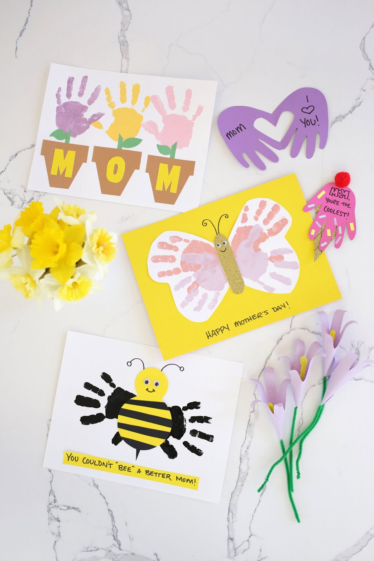 Assortment of Mother's Day handprint crafts on a counter.