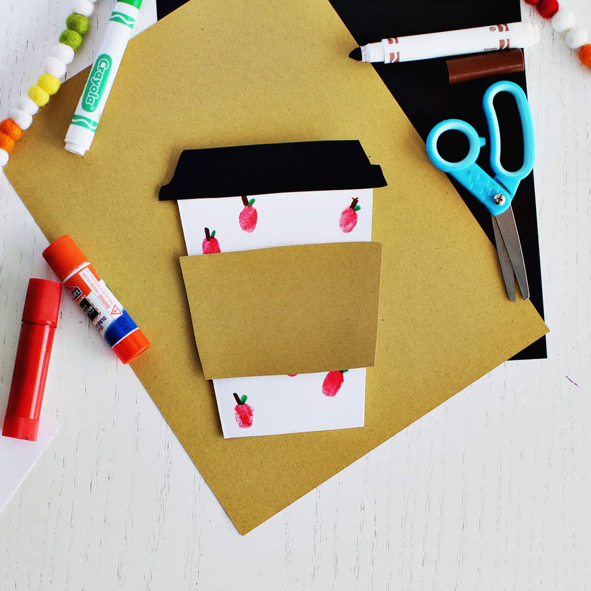 A cup out coffee cup card with fingerprint apples on it.