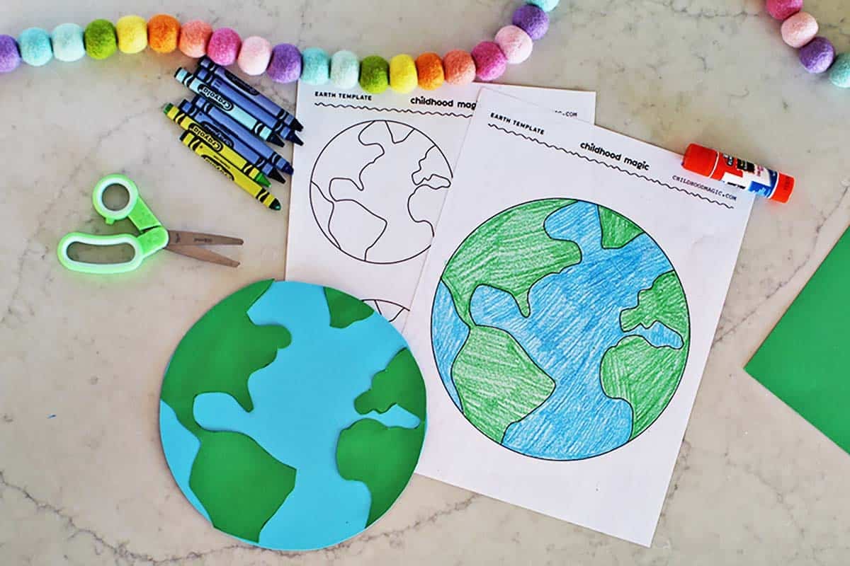 A colored in printable Earth page with an Earth made from blue and green cardstock next to it.