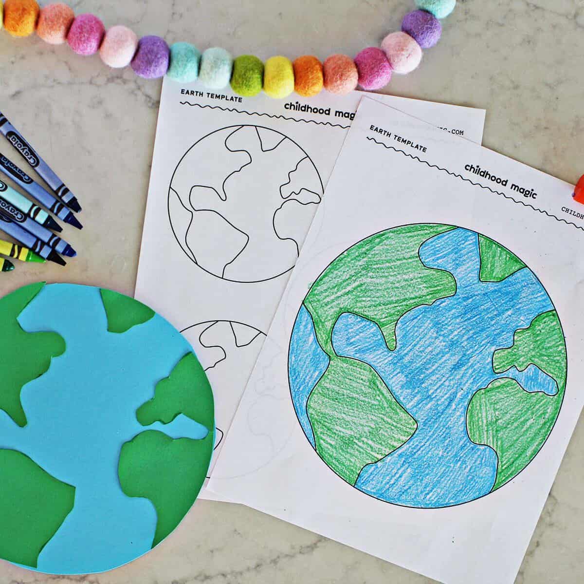 A colored in printable Earth page with an Earth made from blue and green cardstock next to it.