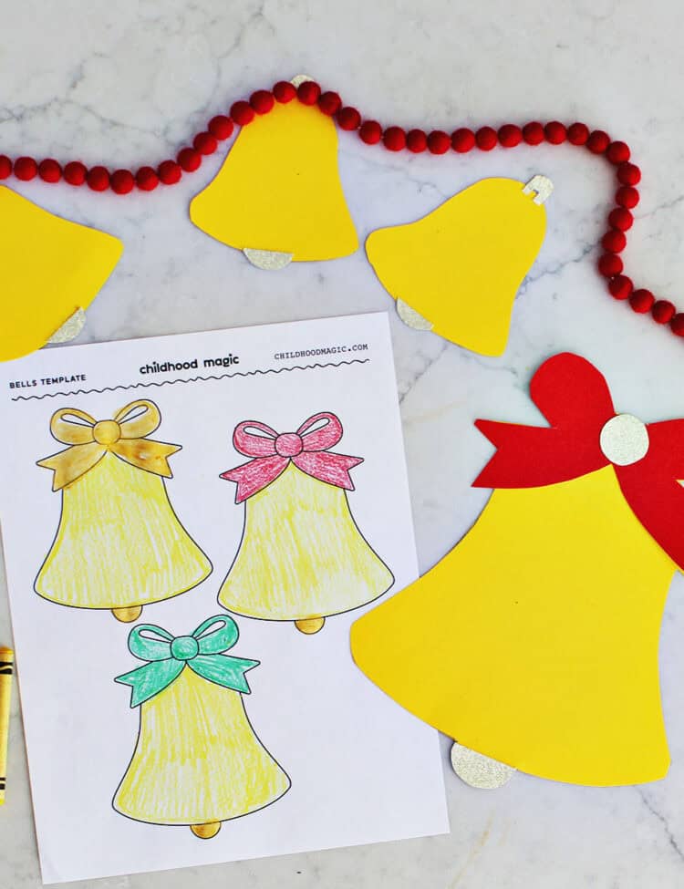 cut out bell shapes on top of printable templates of bells.