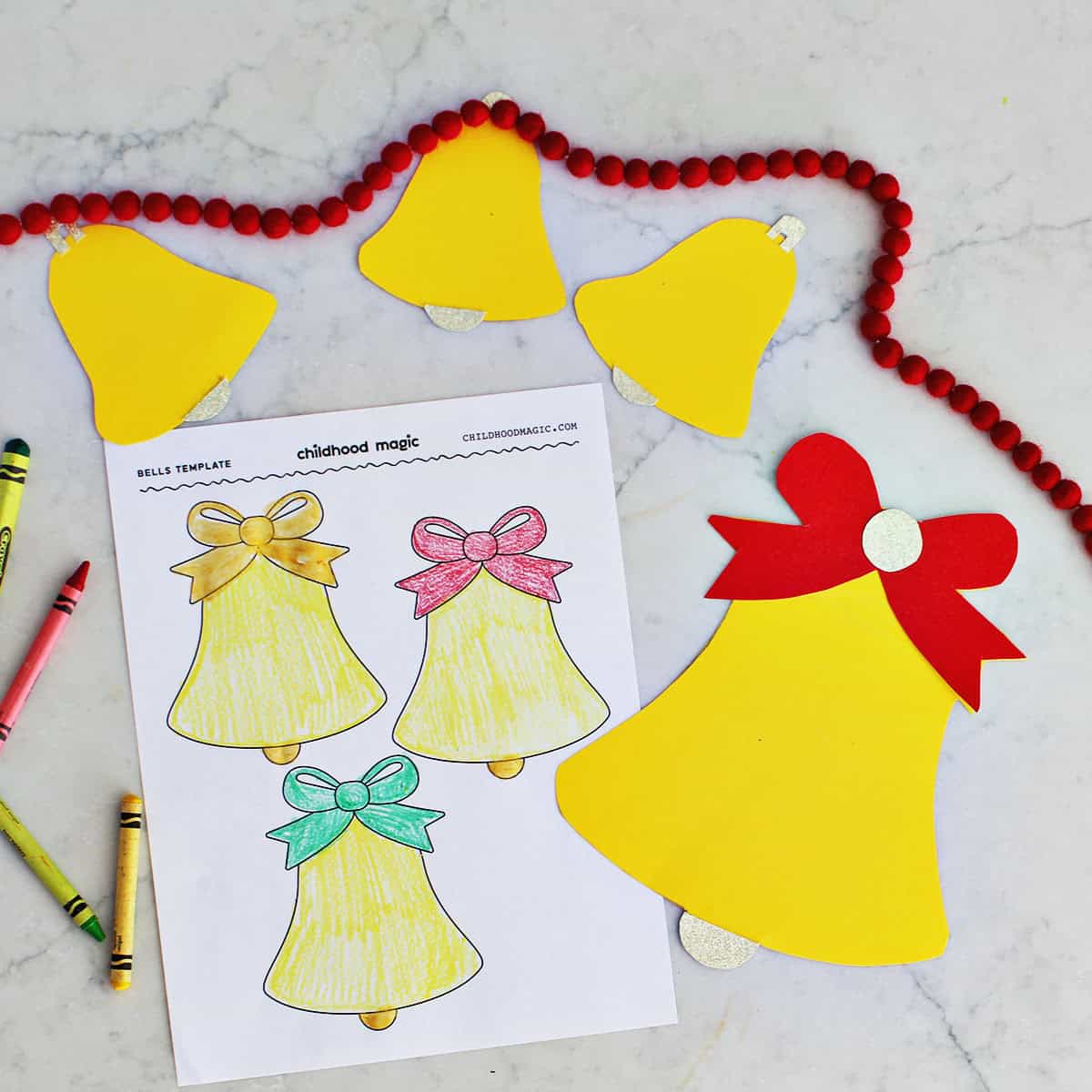 cut out bell shapes on top of printable templates of bells.