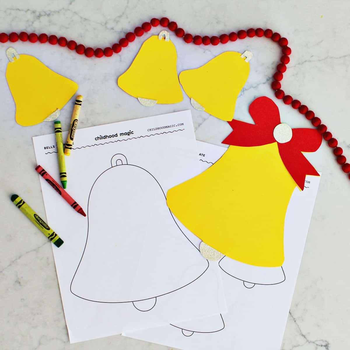 cut out bell shapes on top of printable templates of bells.