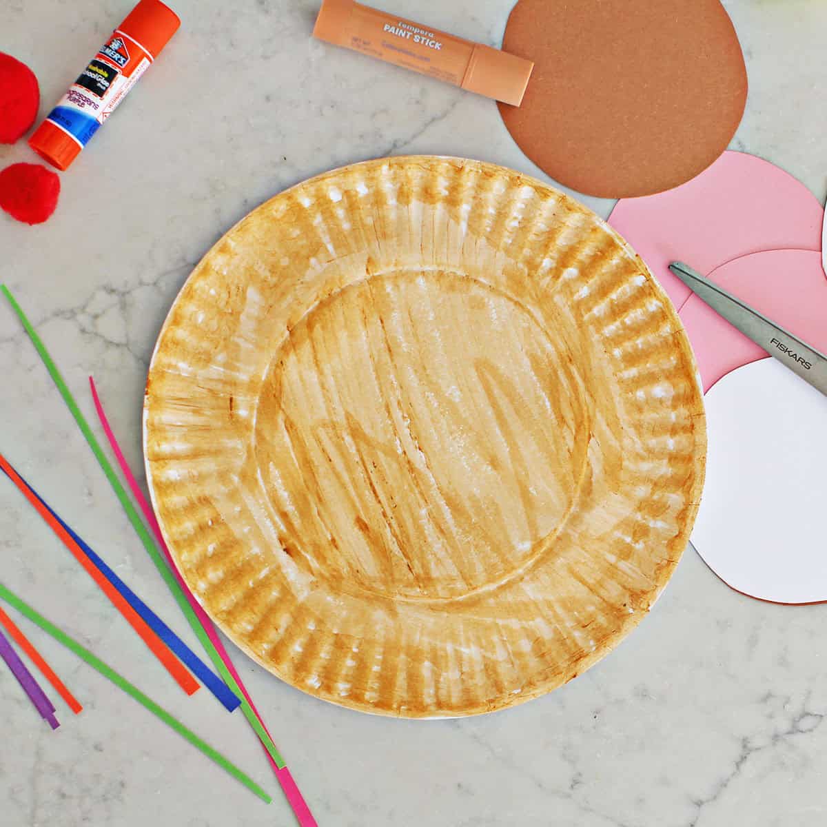paper plate painted a light beige color.