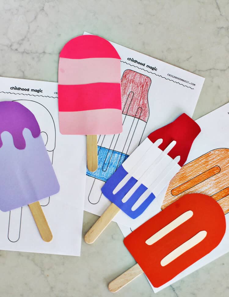 cardstock cut out into the shape of popsicles on a counter.
