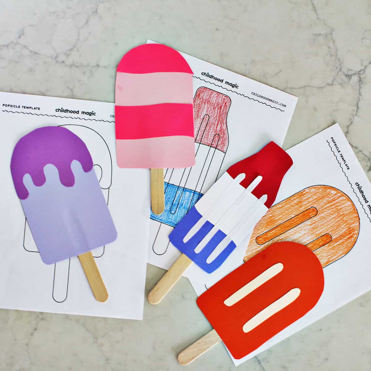 cardstock cut out into the shape of popsicles on a counter.