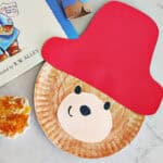 paper plate craft of Paddington Bear sitting next to a muffin with jam and the Paddington Bear book.