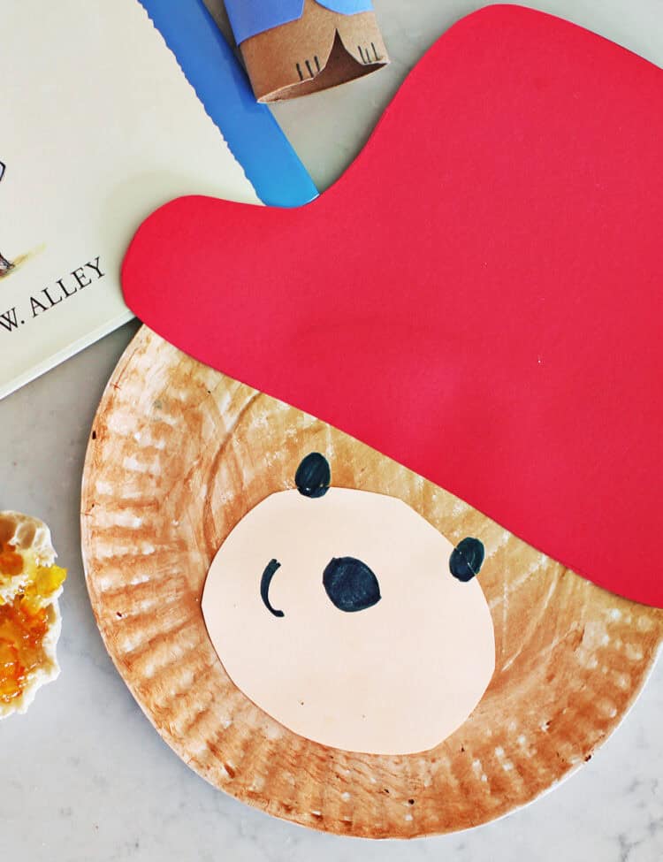 paper plate craft of Paddington Bear sitting next to a muffin with jam and the Paddington Bear book.