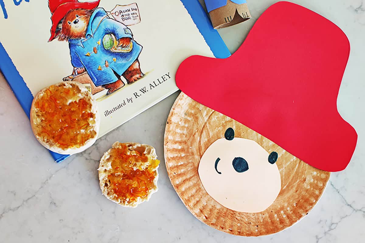 paper plate craft of Paddington Bear sitting next to a muffin with jam and the Paddington Bear book.