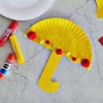 Cardstock glued to half of yellow paper plate painted yellow.
