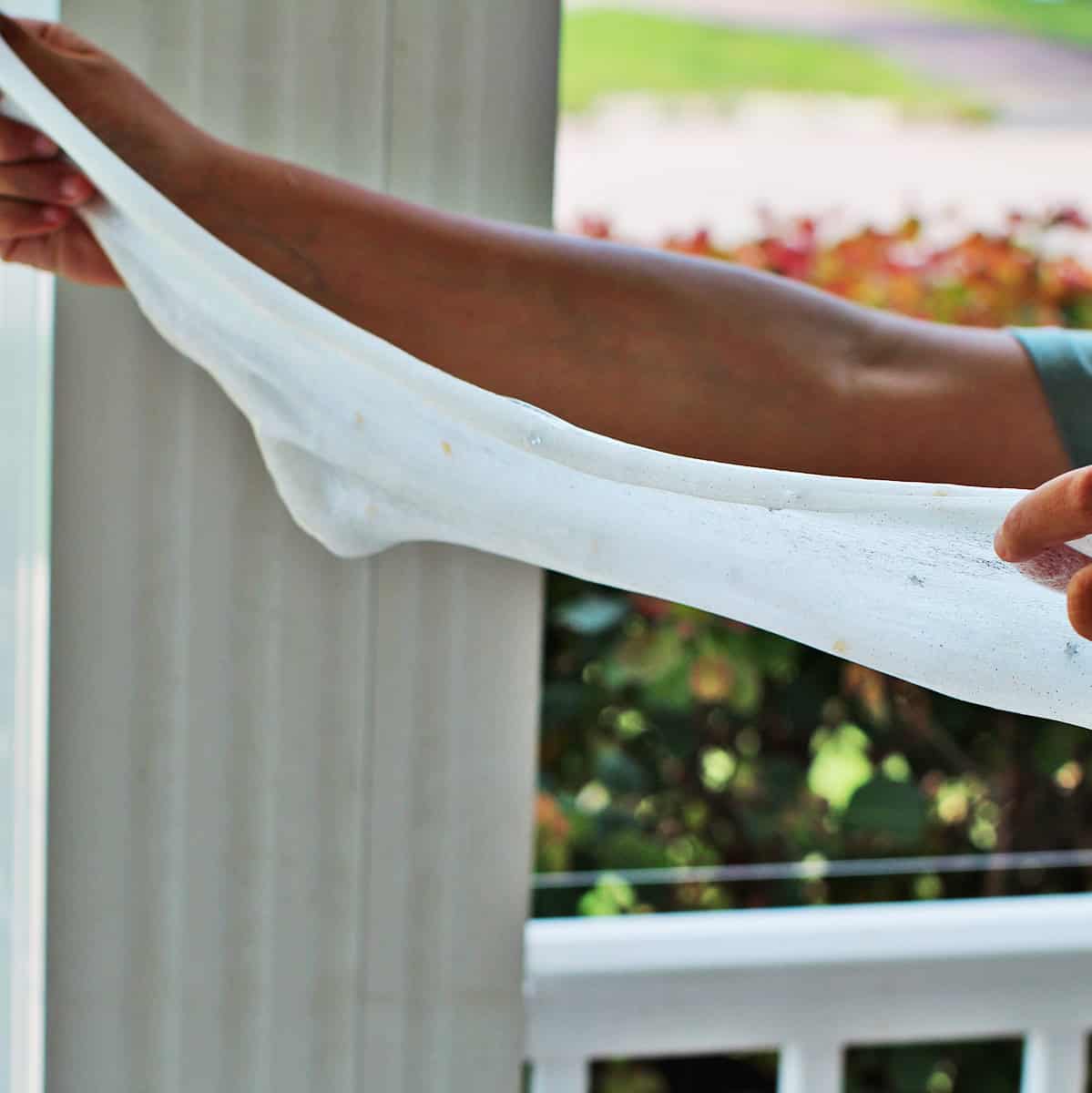 Clear slime being stretched apart.