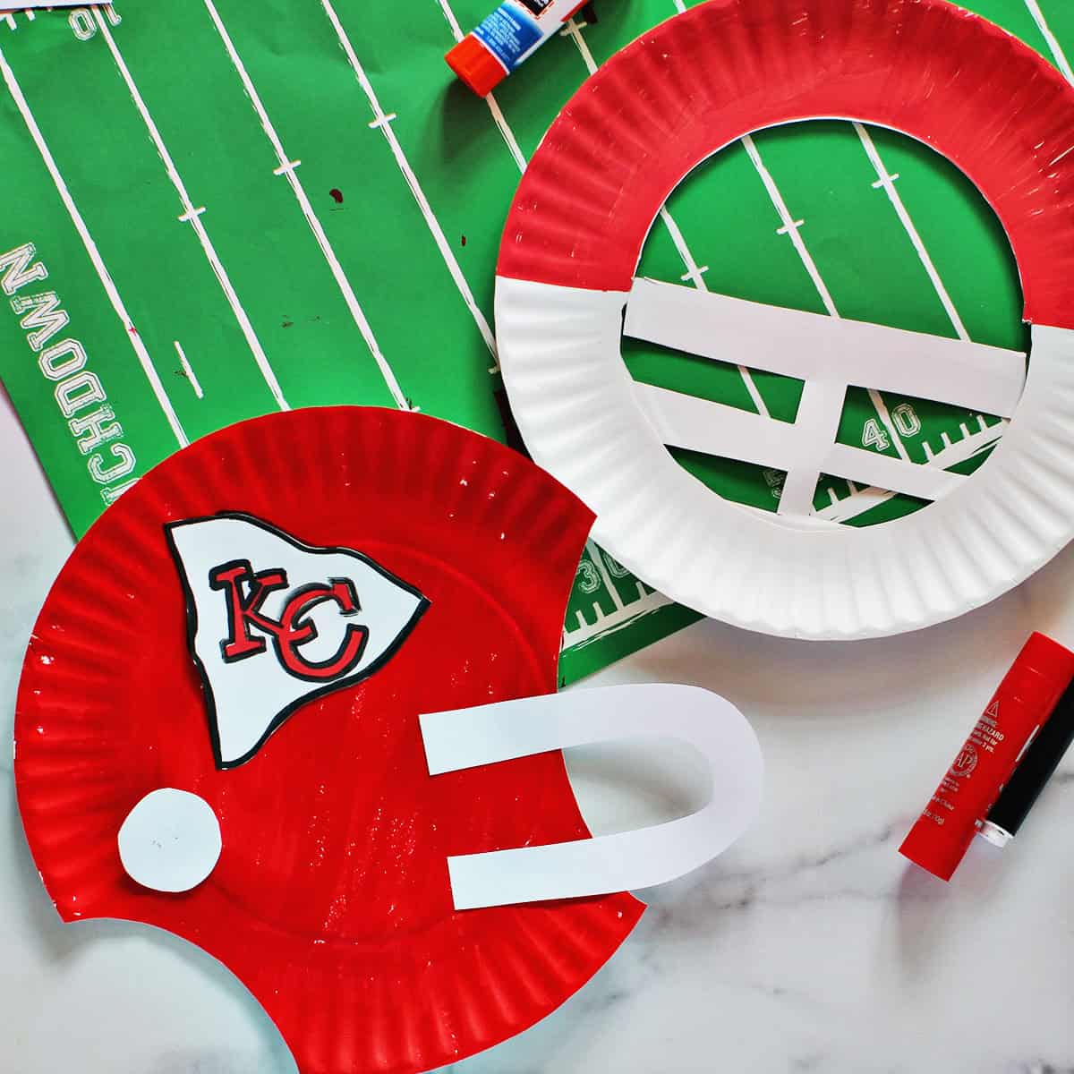 paper plates cut out and decorated to look like helmets for the Kansas City chiefs.