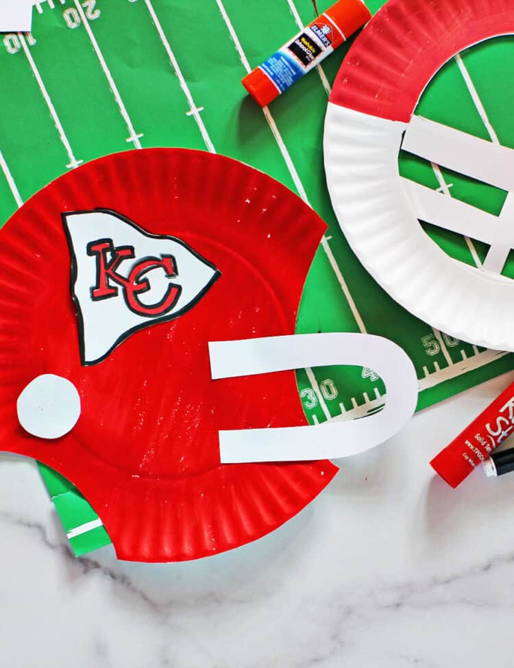 paper plates cut out and decorated to look like helmets for the Kansas City chiefs.