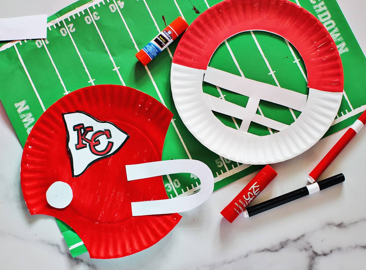 paper plates cut out and decorated to look like helmets for the Kansas City chiefs.