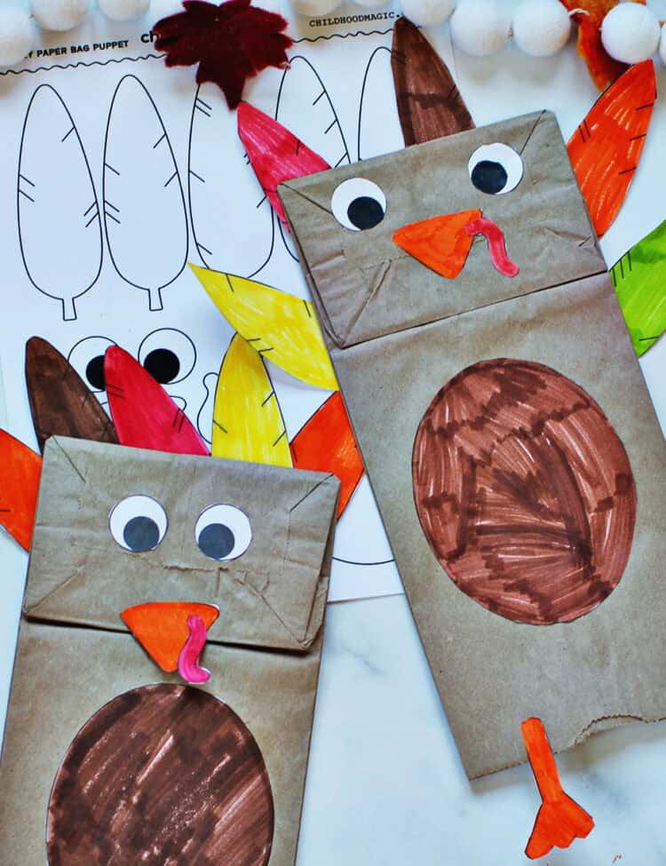 Two paper bags decorated to look like turkies.