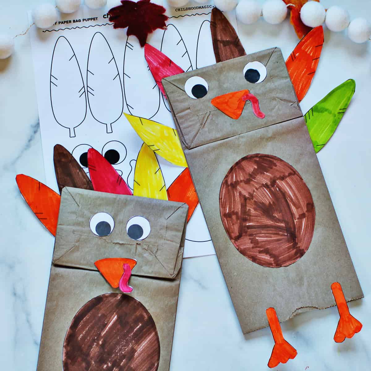 Two paper bags decorated to look like turkies.